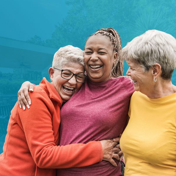 Three mature woman laughing and smiling