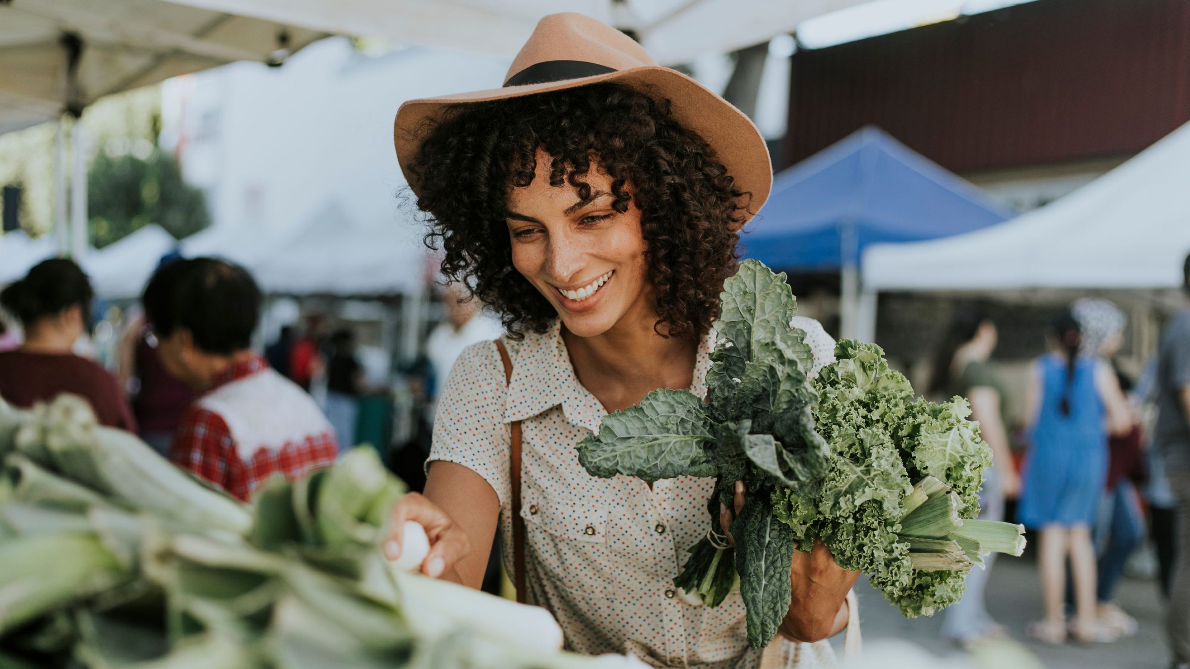 Hawthorne at Holbrook beautiful woman buying kale at a farmers market