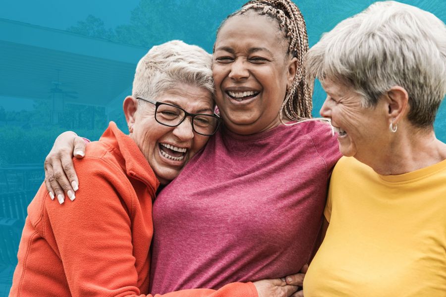 Three mature woman laughing and smiling